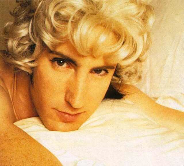 Close up shot of Trent Reznor wearing a blonde wig.